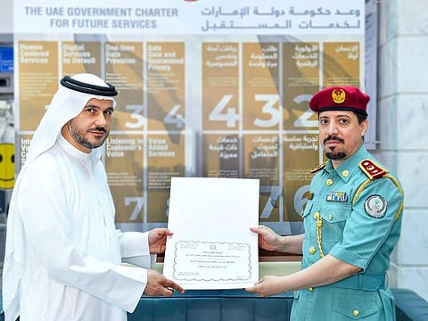 Ziyad Rashid Midhan (left) being honoured by Lieutenant Colonel Muhammad Abdul Rahman bin Qasmol