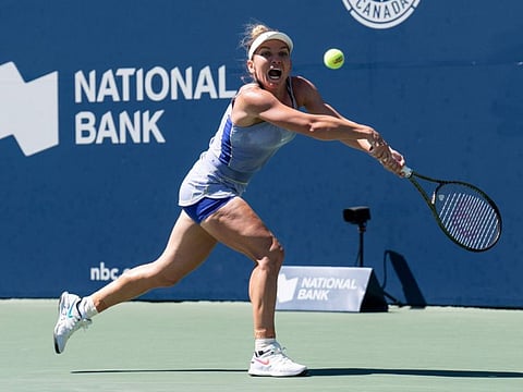 Romania's Simona Halep hits a return to the United States' Coco Gauff during Women's National Bank Open tennis match in Toronto.