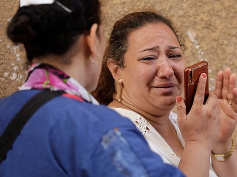 People react after the deadly fire in the church in Egypt on Sunday.