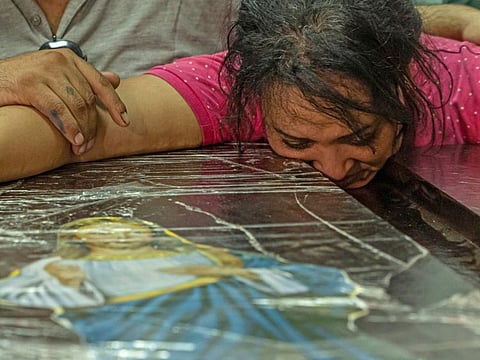 An Egyptian woman mourns during the funeral of victims killed in Cairo Coptic church fire, at the church of the Blessed Virgin Mary in the Giza Governorate on August 14, 2022.