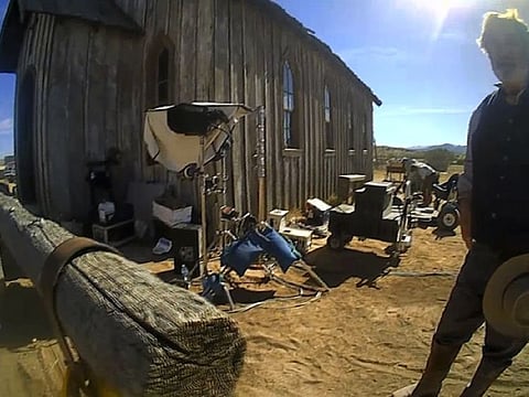 In this image from video released by the Santa Fe County Sheriff's Office, Alec Baldwin stands in costume and speaks with investigators following a fatal shooting last year on a movie set in Santa Fe, New Mexico.
