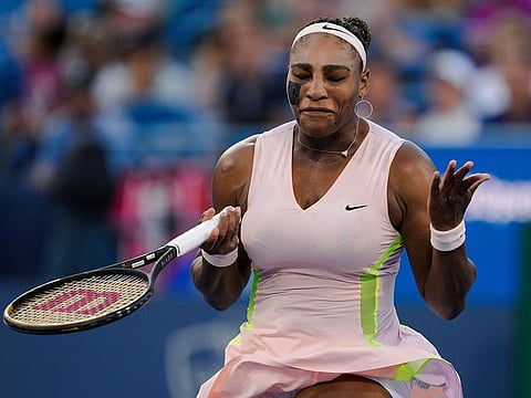 Serena Williams reacts after Emma Raducanu wins a point during the Western & Southern Open tennis tournament Tuesday, Aug. 16, 2022, in Mason, Ohio.