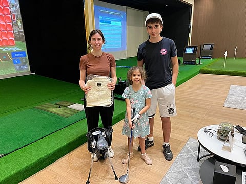 This week's winners in the MyGolf Dubai Junior Practice Competition were Chloe Sakkal (centre) flanked by brother Chukri Sakkal (right), 14, and Mirna Ghanem, Head of Marketing, MyGolf Dubai, with their US Kids Golf and Gulf News prizes.