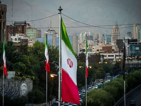 Iranian national flags fly near a major highway through Tehran. Tehran has sought the release of over a dozen Iranians in the United States, including seven Iranian-American dual nationals, two Iranians with permanent US residency and four Iranian citizens with no legal status in the United States.