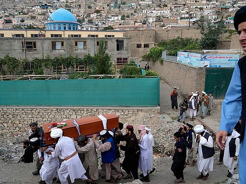 Mourners carry the body of a victim of a mosque bombing in Kabul, on Thursday, August 18. 2022.