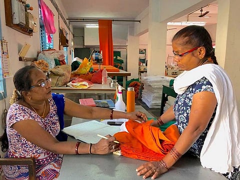 Annapurna Koti examines a finished flag at the national flag making unit in Bengeri, near Hubballi