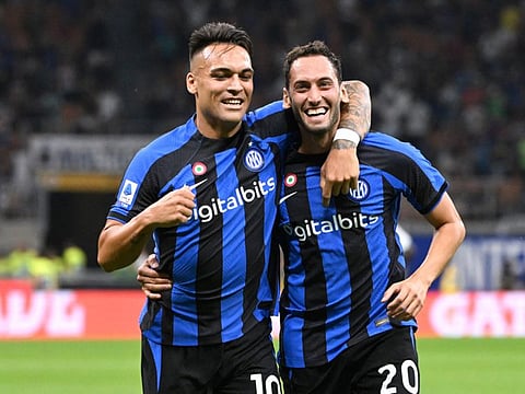 Inter Milan's Hakan Calhanoglu celebrates after scoring their second goal with Lautaro Martinez at San Siro in Milan.