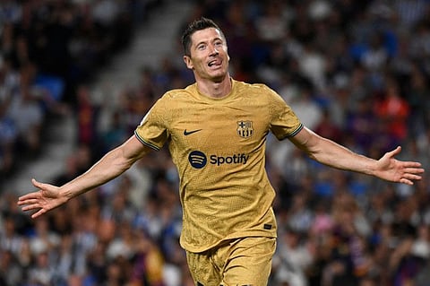 Barcelona's Polish forward Robert Lewandowski celebrates scoring his team's third goal during the Spanish League match against Real Sociedad at the Anoeta stadium in San Sebastian.