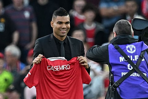 Manchester United's Brazilian midfielder Casemiro is photographed with a United shirt as he is introduced to supporters ahead of the English Premier League football match between Manchester United and Liverpool at Old Trafford in Manchester, north west England.
