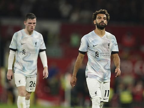 Liverpool's Mohamed Salah (right) and his teammate Andrew Robertson leave the pitch at the end of the English Premier League soccer match against Manchester United at Old Trafford stadium, in Manchester, England.