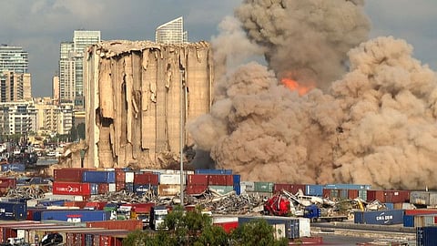 This grab from AFPTV footage shot on August 23, 2022 shows a smoke plume rising after the new collapse of the northern section of the grain silos at the port of Lebanon's capital Beirut, which were previously partly destroyed by the 2020 port explosion.