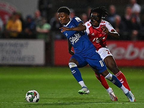 Everton's Demarai Gray (left) runs past Fleetwood Town's Promise Omochere during the League Cup second round match at Highbury Stadium in Fleetwood, north west England.