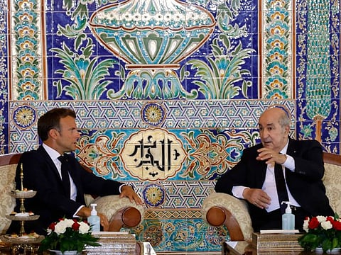 French President Emmanuel Macron (left) and Algeria's President Abdul Madjid Tebboune attend a meeting at the VIP lounge of the airport in Algiers on August 25, 2022, at the start of an official visit to Algeria.