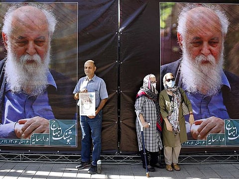 Iranians attend a funeral ceremony for prominent Iranian famous poet Amir Hushang Ebtehaj, also known by his pen name H.E.Sayeh, outside the Vahdat hall in Tehran, on August 26 2022.