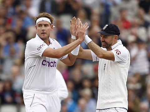England's Stuart Broad celebrates with James Anderson after dismissing South Africa's Keegan Petersen during the first day of the second Test at Old Trafford on Thursday.