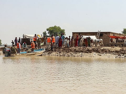 Pakistan army soldiers arrive to evacuate people stranded at a flooded area after heavy monsoon rains in Rajanpur district of Punjab province on August 27, 2022