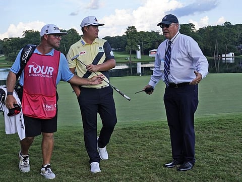 Sungjae Im, of South Korea (centre) leaves the 15th green as he listens to a PGA official as play is suspended during the third round of the Tour Championship golf tournament at East Lake Golf Club Saturday in Atlanta.