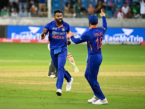 Indian all-rounder Hardik Pandya celebrates one of his three wickets with Virat Kohli during the DP World Asia Cup match against Pakistan at Dubai International Stadium on Sunday.