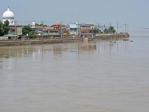 A general view of swollen river Indus is pictured along with residential area in flood hit Sukkur of Sindh province on August 28, 2022.