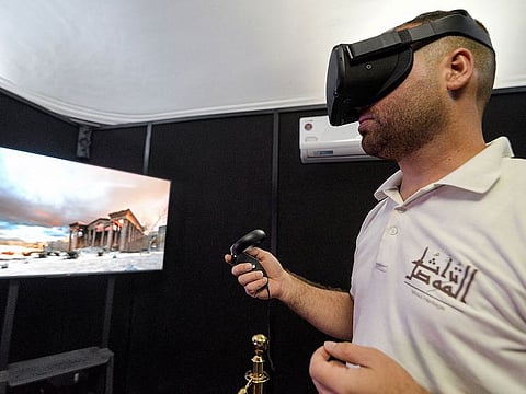 A visitor donning 3D goggles views reconstructed models of ancient artefacts.