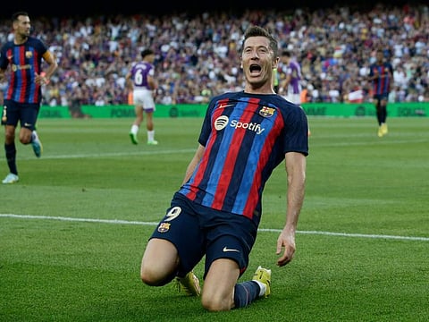 Barcelona's Robert Lewandowski celebrates after scoring his side's opening goal during a Spanish La Liga match against Valladolid CF at the Camp Nou stadium in Barcelona, Spain.