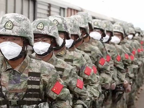 In this handout photo taken from video released by Russian Defence Ministry Press Service on Aug. 29, 2022, Chinese soldiers arrive to the Grodekovo railway station to participate in war games drills, in Grodekovo, Primorsky Krai. Russia said on Monday it will launch sweeping war games drills in the country's east that will involve forces from China — a show of increasingly close military ties between Moscow and Beijing amid tensions with the West over the Kremlin's action in Ukraine.