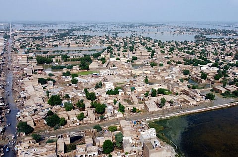 Homes are surrounded by floodwaters in Sohbat Pur city, a district of Pakistan's southwestern Balochistan province, on August 30, 2022. Disaster officials say nearly a half million people in Pakistan are crowded into camps after losing their homes in widespread flooding caused by unprecedented monsoon rains in recent weeks.
