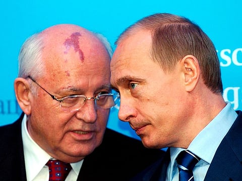 Russia's President Vladimir Putin, right, talks with former Soviet President Mikhail Gorbachev at the start of a news conference at the Castle of Gottorf in Schleswig, northern Germany, Tuesday, Dec. 21, 2004.