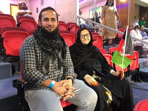 Gulpari Safi and her son Khyber Safi rooting for Afghanistan in the DP World Asia Cup Group B game against Bangladesh at the Sharjah Cricket Stadium on August 30, 2022. She came to the stadium after a chemotherapy session.