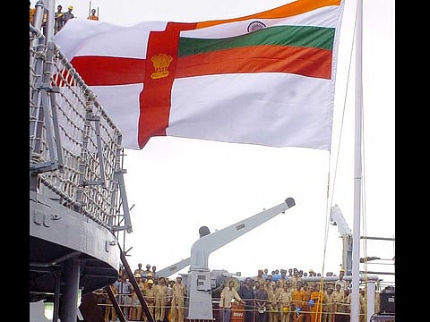 In this file photo taken on July 11, 2005, Indian naval officers raise the naval flag, which features the Cross of Saint George and the Indian national flag, during the commissioning ceremony of the Indian guided missile frigate warship 'INS Beas' in Kolkata.