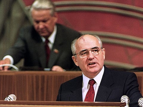 In this file photo taken on June 19, 1990 Soviet President Mikhail Gorbachev (R) addresses the opening session of a conference of Russian communists at the Kremlin while recently elected Russian President Boris Yeltsin stands a desk in the background.