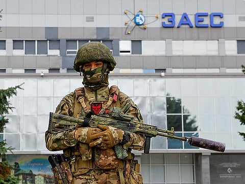 A service member stands guard near the Russian-controlled Zaporizhzhia Nuclear Power Plant following the arrival of the International Atomic Energy Agency (IAEA) expert mission in the course of Ukraine-Russia conflict outside Enerhodar in the Zaporizhzhia region, Ukraine, September 1, 2022.