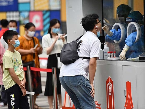 File photo: A health worker takes a swab sample from a man to be tested for the Covid-19 coronavirus in Chengdu, in China's southwestern Sichuan province on September 1, 2022.