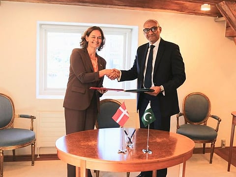 Pakistan's Ambassador to Denmark Ahmad Farooq exchanging documents with Denmark’s outgoing ambassador in Pakistan Lis Rosenholm after signing the Green Framework Engagement Agreement.
