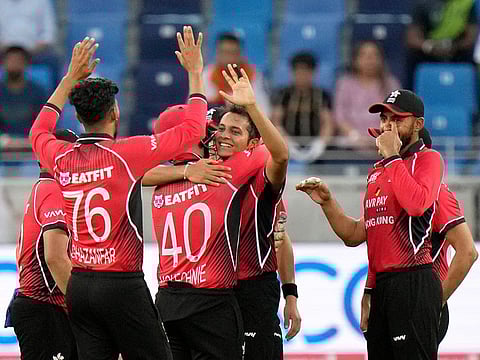 Hong Kong's Ayush Shukla, center, celebrates with teammates after taking the wicket of India's Rohit Sharma during the T20 Asia Cup match against India, in Dubai, on August 31, 2022.