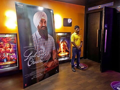 A ticket checker waits for film-goers at the gate of a cinema hall showcasing Aamir Khan-starrer 'Laal Singh Chaddha', an official remake of the 1994 film 'Forrest Gump' in Ahmedabad, India, August 26, 2022.