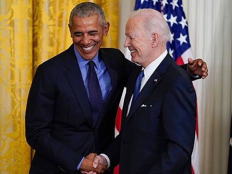 File photo: President Joe Biden and former President Barack Obama shake stand together on stage during an event about the Affordable Care Act, in the East Room of the White House in Washington, on April 5, 2022.