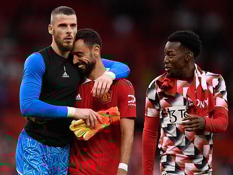 Manchester United's goalkeeper David de Gea (left), midfielder Bruno Fernandes (centre) and striker Anthony Elanga leave the pitch after the English Premier League football match against Arsenal at Old Trafford in Manchester, north west England.