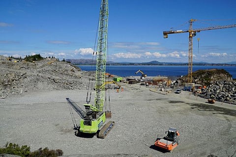 A photo taken on June 21, 2021 in Oygarden near Bergen, Norway, shows cranes and vehicles at a construction site at the start of construction work for a terminal which will collect liquefied carbon dioxide CO2, which will arrive by ship from industrial facilities in Europe and will run through a pipeline into geological formations deep beneath the sea bed, so that it doesn't contribute to global warming.