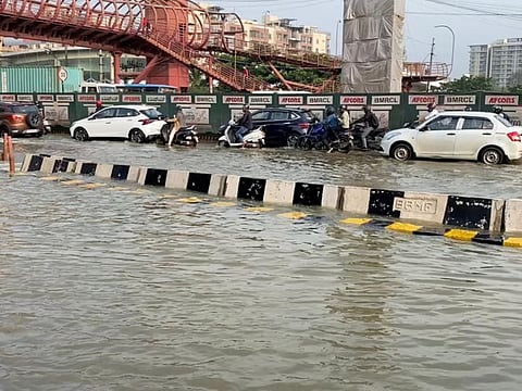Vehicles drive along a waterlogged road in Bengaluru, Karnataka state, India in this screen grab taken from a social media video September 5, 2022.