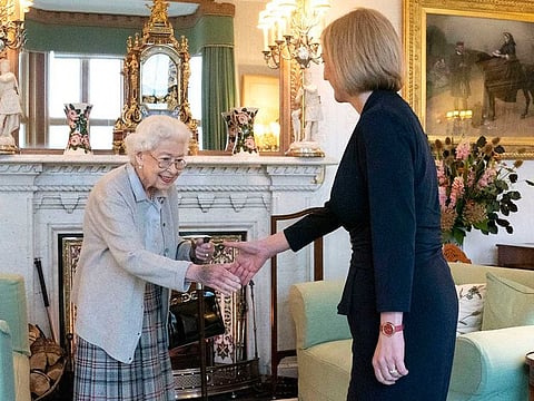 Britain's Queen Elizabeth II, left, welcomes Liz Truss during an audience at Balmoral, Scotland, where she invited the newly elected leader of the Conservative party to become Prime Minister and form a new government, Tuesday, Sept. 6, 2022.
