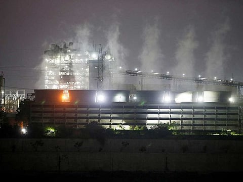 Smoke billows from the cooling towers of a coal-fired power plant in Ahmedabad, India, October 13, 2021.