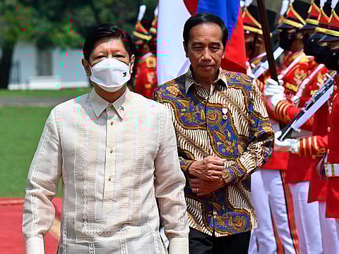 Philippine President Ferdinand Marcos Jr., left, escorted by Indonesian President Joko Widodo inspects an honor guard upon his arrival at the Presidential Palace in Bogor, West Java, Indonesia.