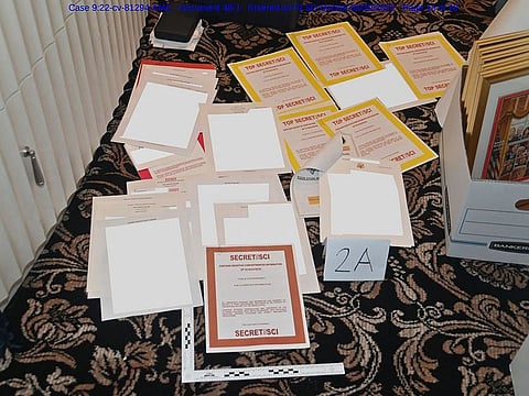 This undated file photo released by the US Department of Justice on August 31, 2022 shows a photo attached as evidence to a court filing by the US District Court Southern District of Florida, of documents allegedly seized at Mar-a-Lago spread over a carpet.