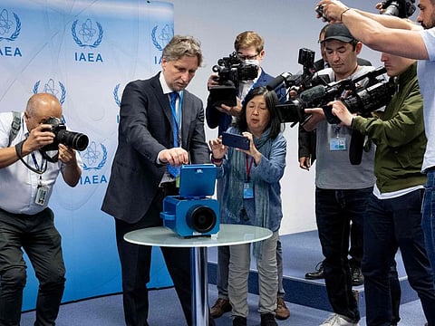 Photographers and TV cameramen watch a demonstration of a monitoring camera used in Iran during a press conference of Rafael Grossi, Director General of the International Atomic Energy Agency (IAEA) about the current situation in Iran at the agency's headquarters in Vienna, in this June 09, 2022, file photo.