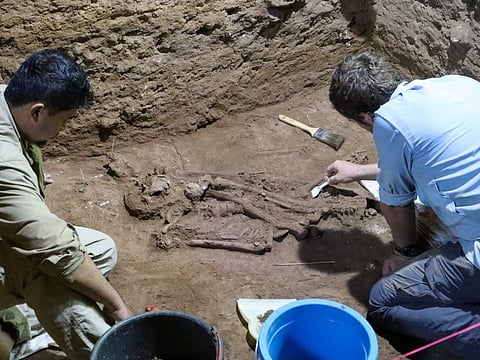 Dr Tim Maloney and Andika Priyatno work at the site in a cave in East Kalimantan, Borneo, Indonesia, March 2, 2020. The remains, which have been dated to 31,000 years old, mark the oldest evidence for amputation yet discovered.