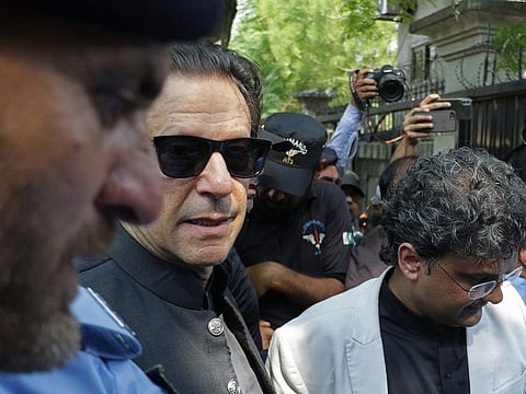 Former Pakistan's prime minister Imran Khan (centre) arrives in a court for a case hearing in Islamabad on September 8, 2022.