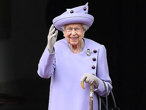 In this file photo taken on June 28, 2022 Britain's Queen Elizabeth II waves as she attends an Armed Forces Act of Loyalty Parade at the Palace of Holyroodhouse in Edinburgh, Scotland.