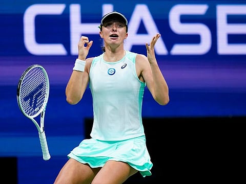 Iga Swiatek of Poland reacts after defeating Aryna Sabalenka during the semi-finals of the US Open in New York on Wednesday.
