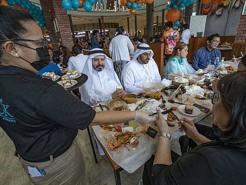 Diners at Off The Hook Seafood Restaurant in Manar Mall, Ras Al Khaimah, which was founded by the friends